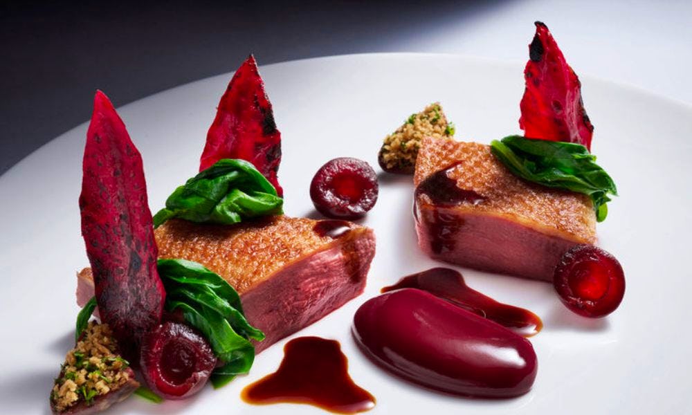 A plate of duck breast from Dinner by Heston in Dubai