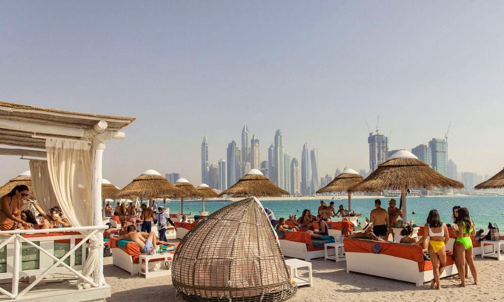 Beach club with Dubai skyline in the background